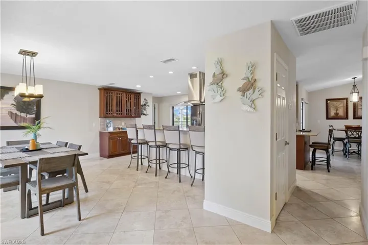 Dining room featuring light tile patterned flooring and recessed lighting