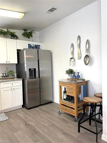 SPACIOUS KITCHEN WITH LUXURY VINYL PLANK FLOORING, WHITE SHAKER CABINETS WITH SOFT CLOSE DOORS & GRANITE COUNTERTOPS, BRILLIANT STAINLESS APPLIANCES. REFRIGERATOR OFFERS FILTERED WATER/ICE ON THE DOOR. LARGE PANTRY AND A DOUBLE STAINLESS SINK WITH WINDOW VIEW OF THE FRONT YARD TO ENJOY THE PLANTS, BIRDS, BUNNIES.