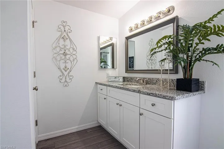 BATHROOM - MAIN BATHROOM.WALK-IN SHOWER, NEW SHAKER CABINETS WITH SOFT CLOSE DOORS, GRANITE COUNTERTOP, NEW TOILET, LUXURY VINYL PLANK FLOORING. NEW LIGHT, NEW MIRROR, LINEN CLOSET.