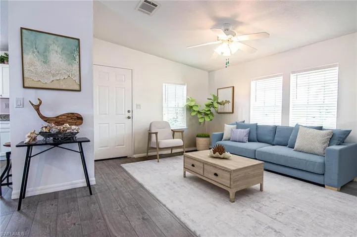 LIVING ROOM OPENS TO THE DINING ROOM AND KITCHEN. VAULTED CEILINGS. REMODELED. NEW LUXURY VINYL PLANK FLOORING.