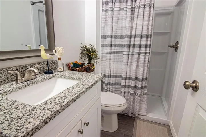 BATHROOM - GUEST.WALK-IN SHOWER, NEW SHAKER CABINETS WITH SOFT CLOSE DOORS, GRANITE COUNTERTOP, NEW TOILET, LUXURY VINYL PLANK FLOORING.