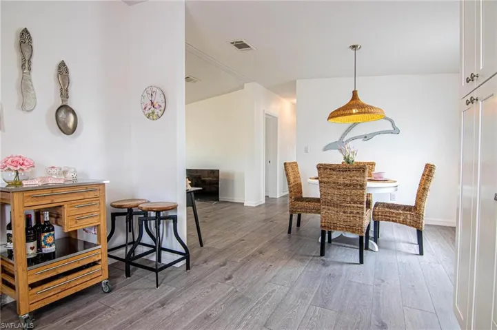 DINING ROOM TO KITCHEN WITH NEW STAINLESS APPLIANCES. REFRIGERATOR WITH FILTERED WATER AND ICE ON THE DOOR. NEW SHAKER CABINETS WITH SOFT CLOSE DOORS AND NEW LUXURY VINYL PLANK FLOORING. VAULTED CEILINGS. REMODELED FROM CEILING DOWN.
