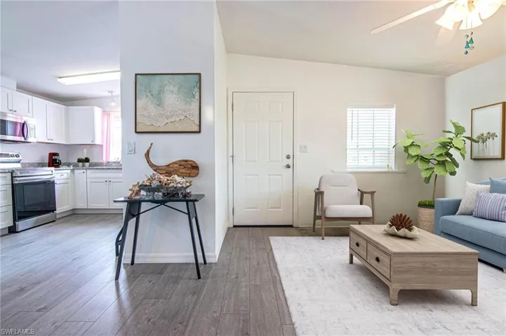 LIVING ROOM OPENS TO THE DINING ROOM AND KITCHEN. VAULTED CEILINGS. REMODELED. NEW LUXURY VINYL PLANK FLOORING.