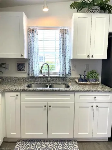 SPACIOUS KITCHEN WITH LUXURY VINYL PLANK FLOORING, WHITE SHAKER CABINETS WITH SOFT CLOSE DOORS & GRANITE COUNTERTOPS, BRILLIANT STAINLESS APPLIANCES. REFRIGERATOR OFFERS FILTERED WATER/ICE ON THE DOOR. LARGE PANTRY AND A DOUBLE STAINLESS SINK WITH WINDOW VIEW OF THE FRONT YARD TO ENJOY THE PLANTS, BIRDS, BUNNIES.