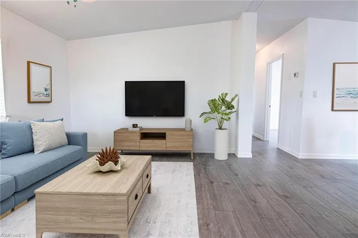 LIVING ROOM OPENS TO THE DINING ROOM AND KITCHEN. VAULTED CEILINGS. REMODELED. NEW LUXURY VINYL PLANK FLOORING.