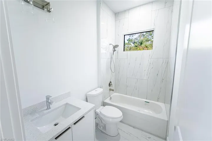 Full bathroom featuring vanity, toilet, and shower / bath combination