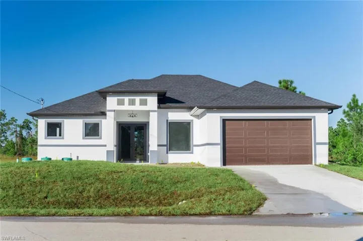 Prairie-style home featuring a garage and a front yard