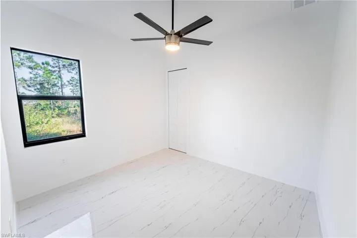 Spare room with ceiling fan