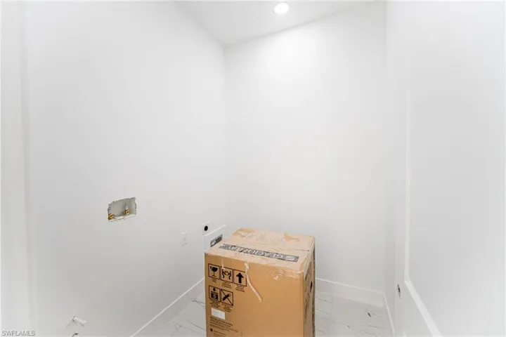 Washroom featuring hookup for an electric dryer and hookup for a washing machine