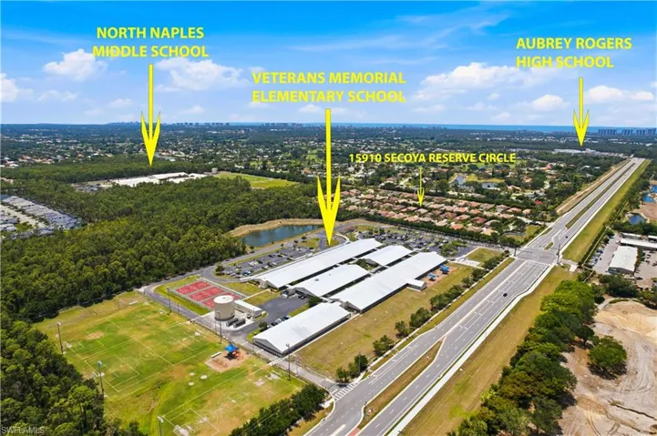 Aerial perspective showcasing the surrounding neighborhood and extensive green spaces