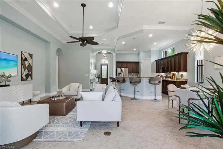 Spacious living room with designer lighting and tray ceilings