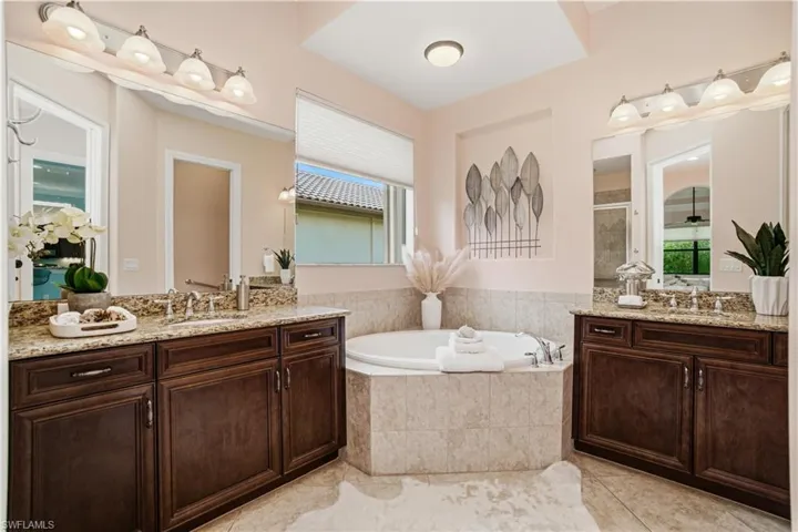 Luxurious primary bathroom with dual vanities and soaking tub