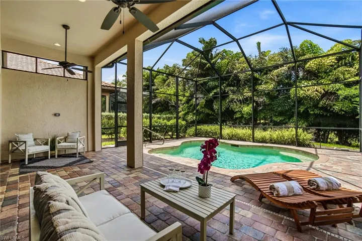 Private resort-style pool surrounded by tropical landscaping
