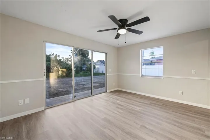Empty room with light wood finished floors and ceiling fan