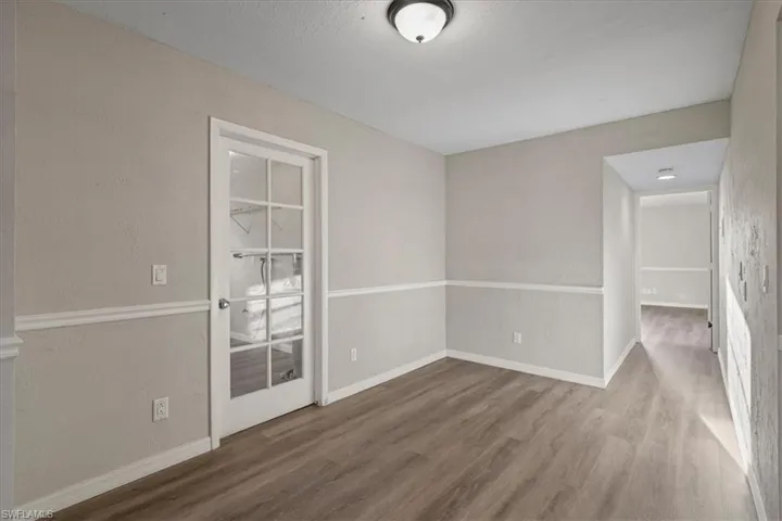 Empty room featuring wood finished floors and a textured ceiling