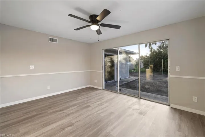 Spare room featuring wood finished floors and a ceiling fan