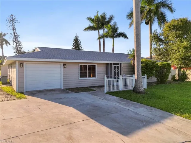 Single story home with concrete driveway, roof with shingles, and a garage