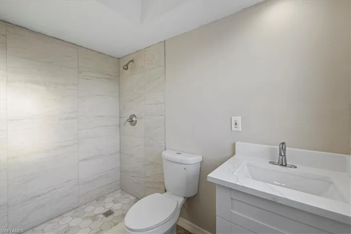 Bathroom featuring a shower stall and vanity