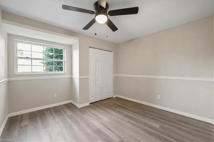 Unfurnished bedroom featuring light wood finished floors, a closet, and ceiling fan