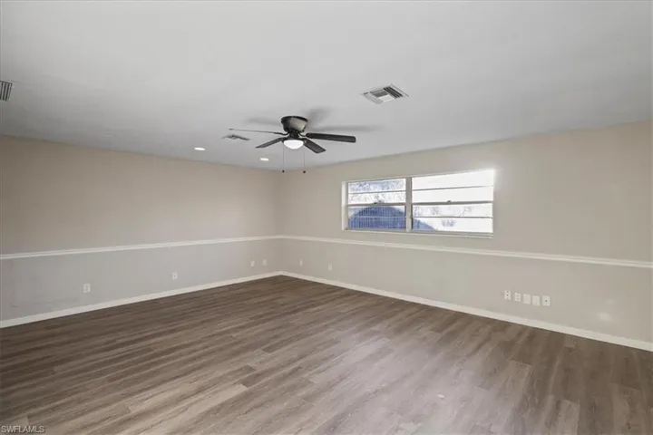 Unfurnished room with wood finished floors, a ceiling fan, and recessed lighting
