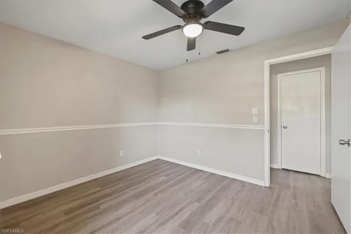 Unfurnished room featuring light wood finished floors and a ceiling fan