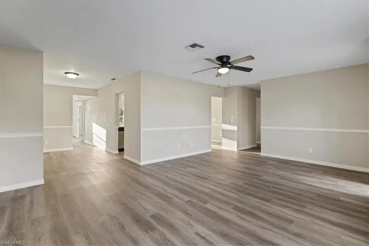 Empty room featuring light wood-type flooring and a ceiling fan