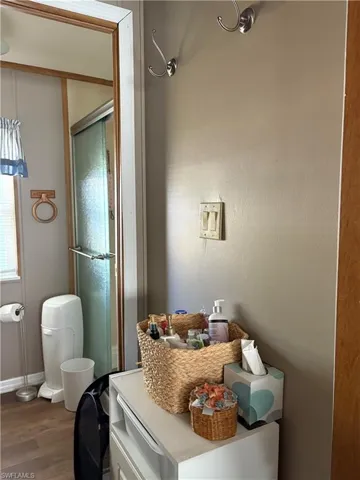 Bathroom with wood-type flooring and a shower with door