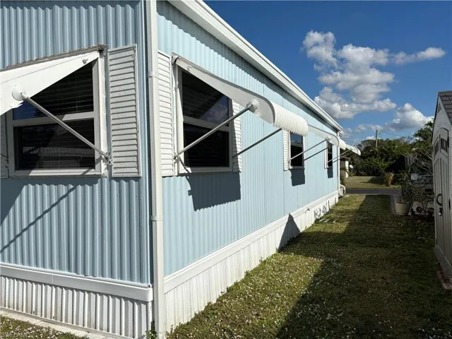 View of side of home with a lawn