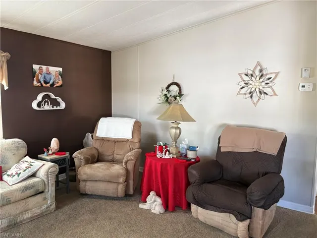 Sitting room featuring carpet floors