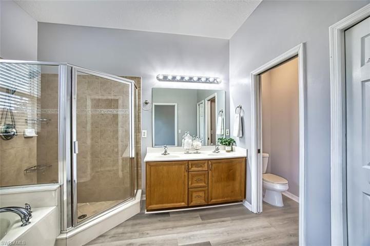 Primary Bathroom with dual sinks, shower and tub