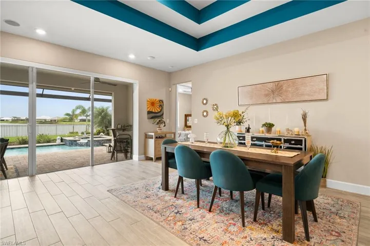 Dining room featuring wood-look tile floors and recessed lighting