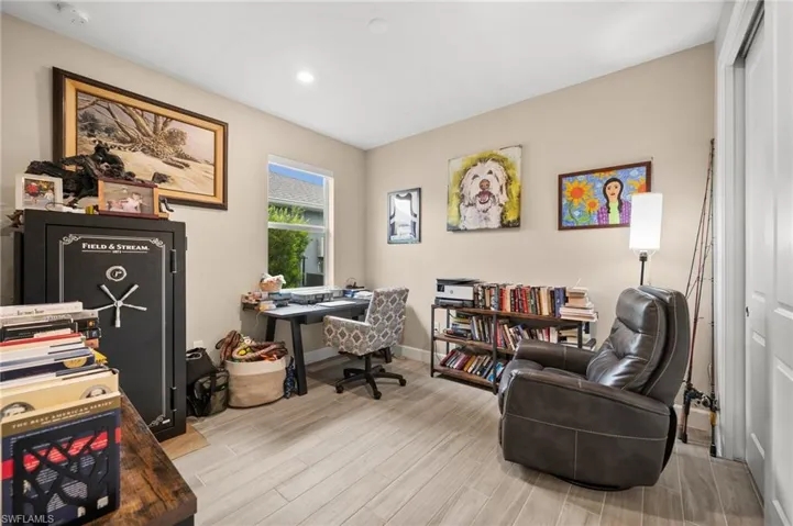 Office area with wood-look tile floors and recessed lighting