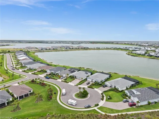 Aerial view of residential area featuring a nearby body of water