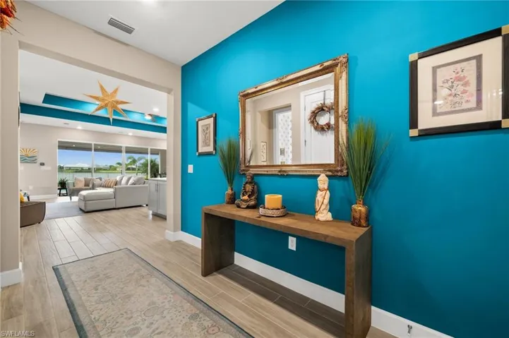 Hallway with baseboards and wood-look tile floors