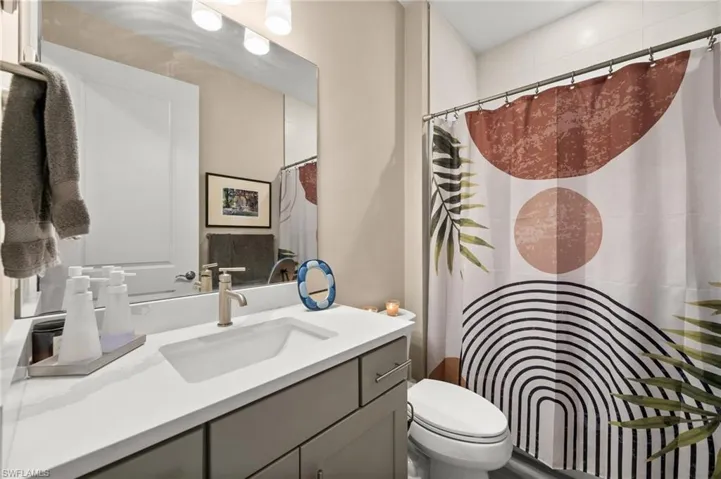 Full bath with vanity and curtained shower