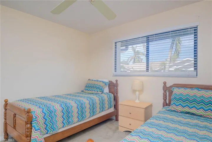 Bedroom with light carpet and ceiling fan