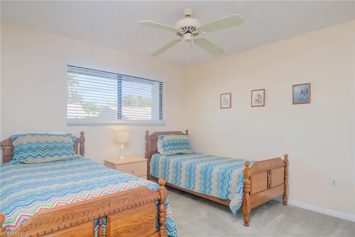 Bedroom with ceiling fan and carpet flooring