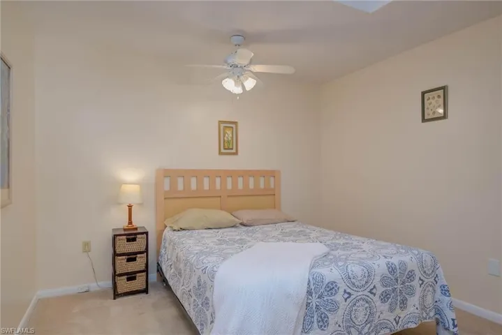 Bedroom featuring light colored carpet and ceiling fan