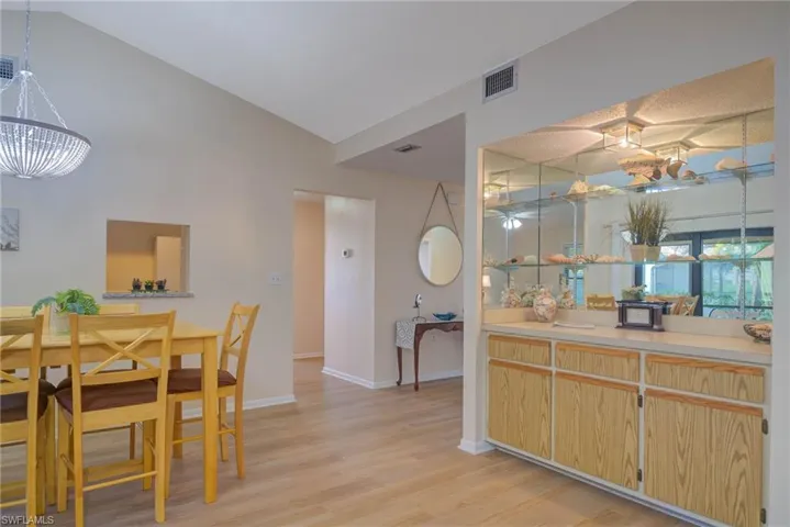 Dining space featuring lofted ceiling and light wood-type flooring