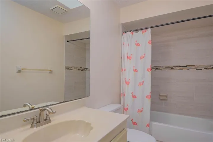 Full bathroom with vanity, toilet, and shower / tub combo with curtain