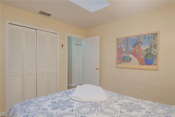 Bedroom with a skylight and a closet