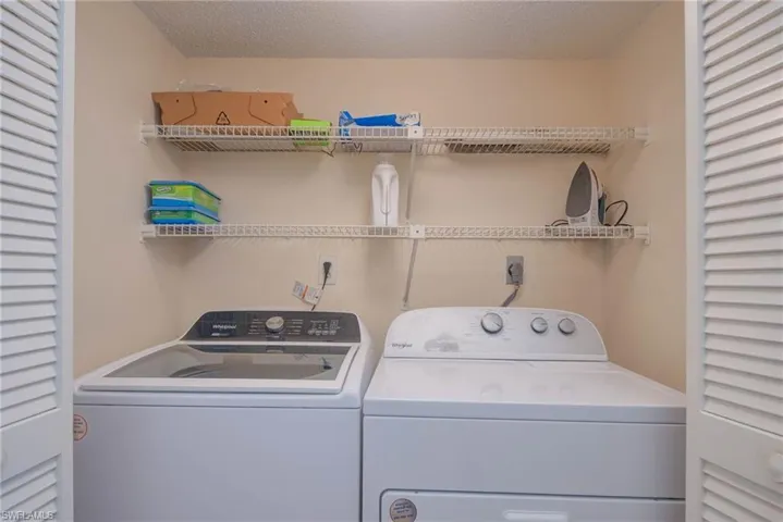 Laundry area featuring separate washer and dryer inside residence