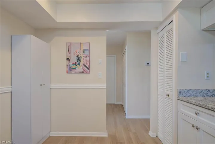 Corridor with light hardwood / wood-style floors
