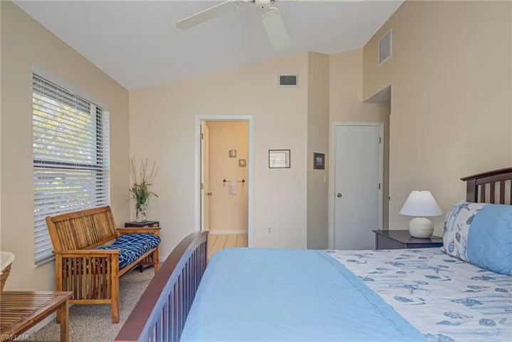 Bedroom featuring ceiling fan and lofted ceiling