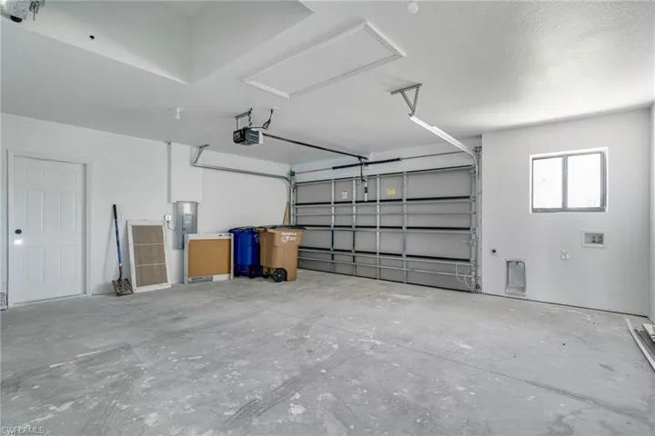 Garage with electric panel and a garage door opener