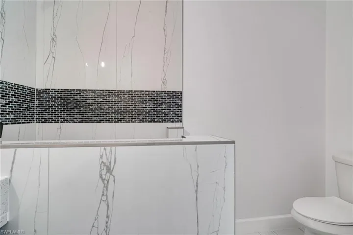 Bathroom featuring toilet and baseboards