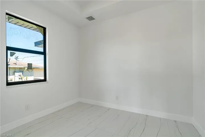 Empty room featuring baseboards and light marble finish flooring