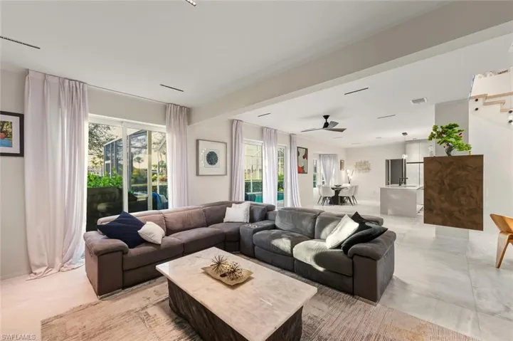 Living area featuring a ceiling fan and concrete flooring