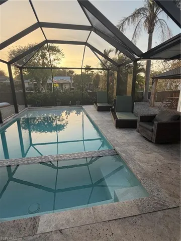 Combined pool / hot tub featuring a patio, a lanai, and a sunroom