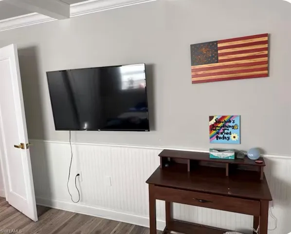 Detailed view of wainscoting and wood finished floors